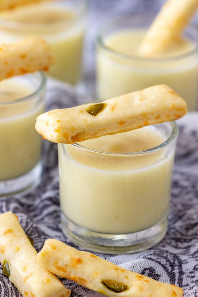 Potato and leek soup shooters with breadstick on top.