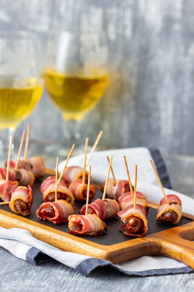 Bacon wrapped dates on a platter.