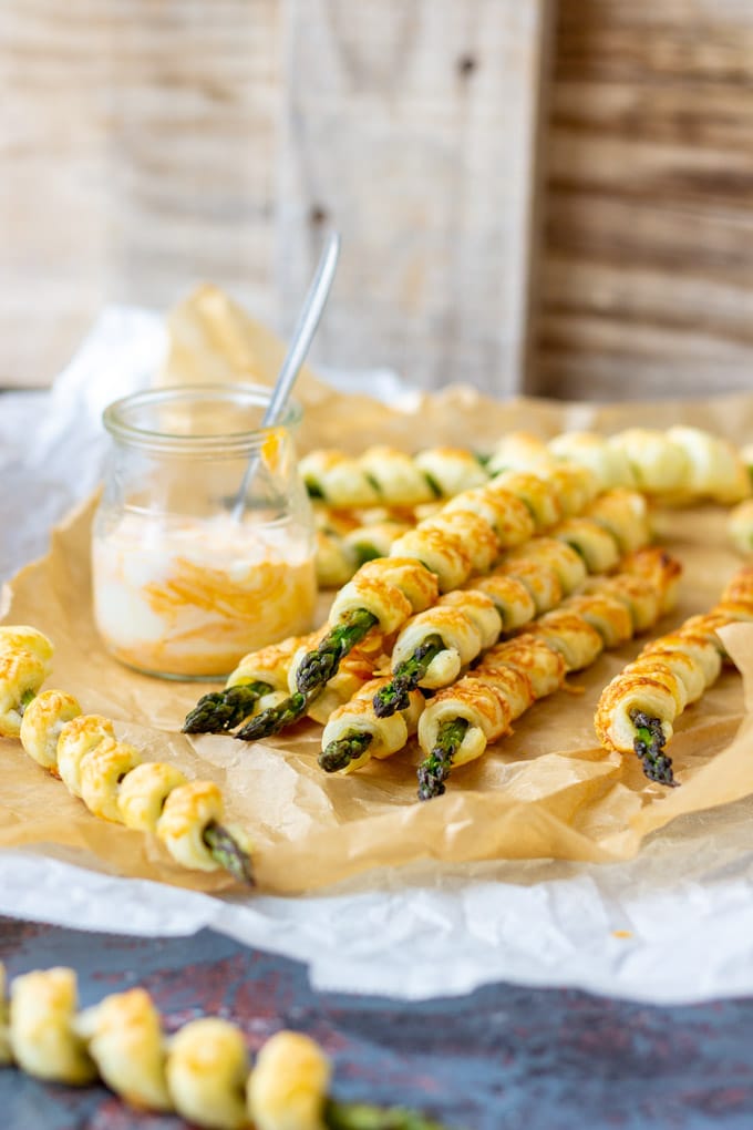 Parmesan asparagus pastry twists with dipping sauce.