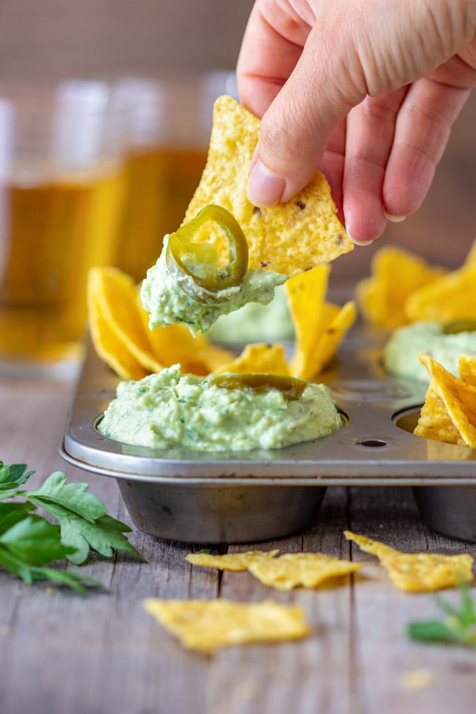 Dipping tortilla chip to roasted garlic jalapeno dip.