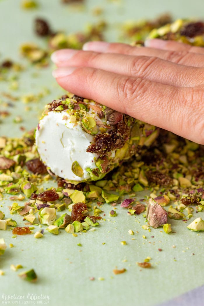 Rolling the Goat Cheese Log on the crushed pistachios