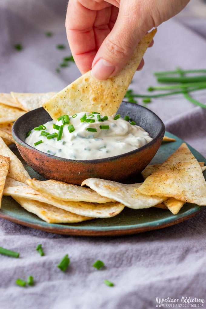 Eating Tortilla Chips with Sour Cream and Chive Dip