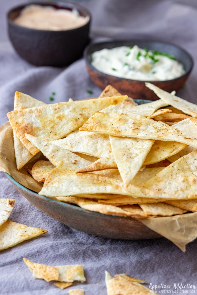 Bowl of oven baked tortilla chips with dip.