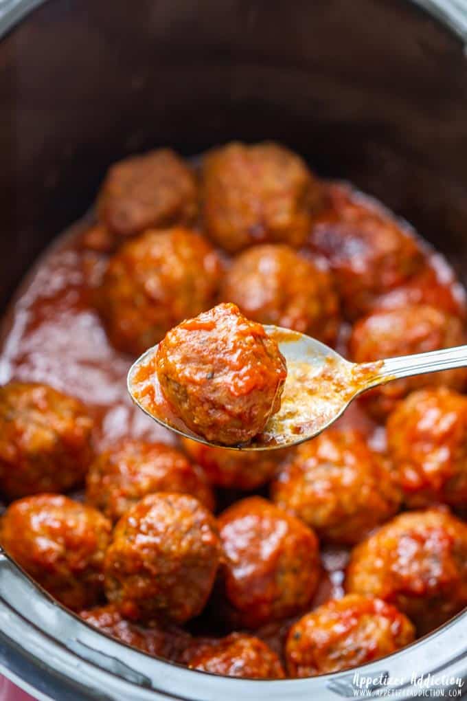 Slow cooker sweet and spicy meatball on a spoon.