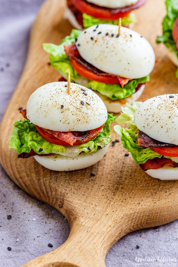 BLT egg slider appetizers on the wooden board.