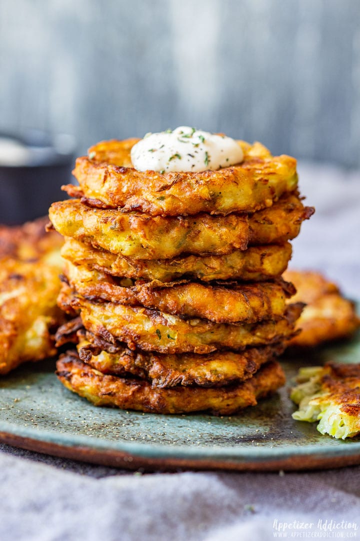 Stacked zucchini fritters on the plate.