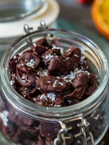 Chocolate covered cranberries sprinkled with coconut flakes