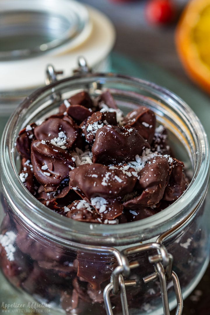 Chocolate covered cranberries sprinkled with coconut flakes