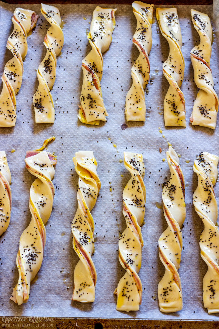 Uncooked puff pastry twists on the baking tray