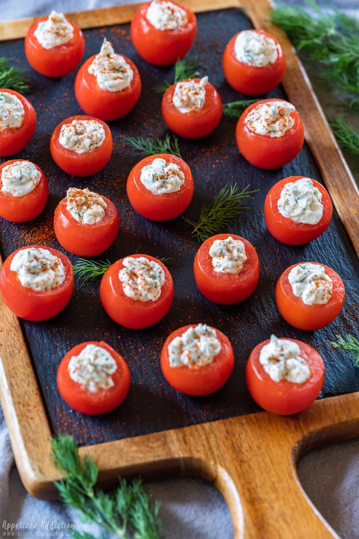 Filled cherry tomatoes on the board