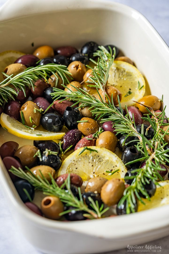 Olives, lemon slices and rosemary ready to be baked