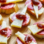 Manchego cheese tapas with chorizo, fig jam and black pepper.