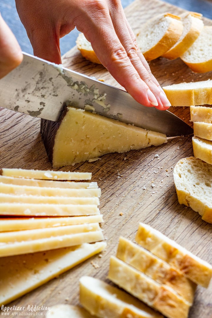 Slicing Spanish Manchego cheese