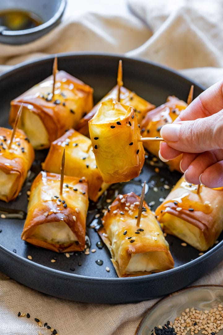 Baked feta bite in phyllo pastry on a cocktail stick