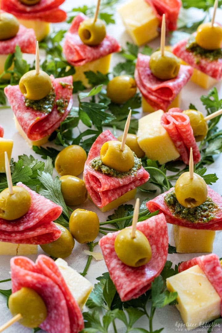 Plate filled with party appetizers with cheese and salami