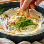 Scooping whipped feta dip with tortilla chips