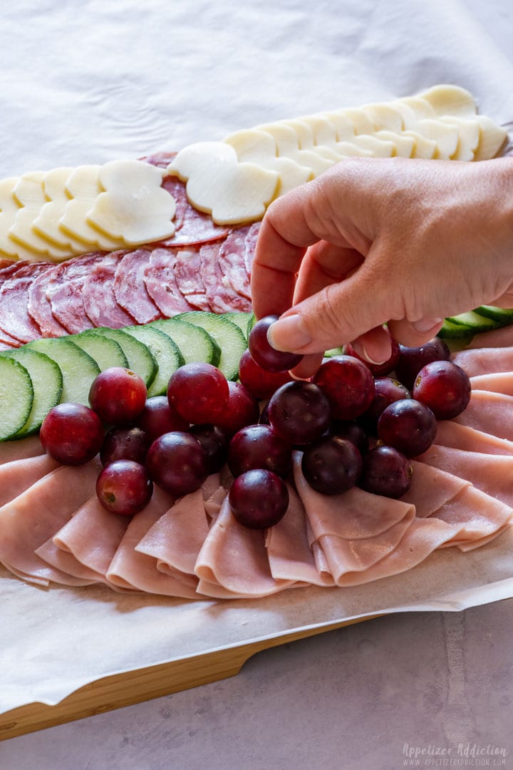 Assembling Easter egg charcuterie board