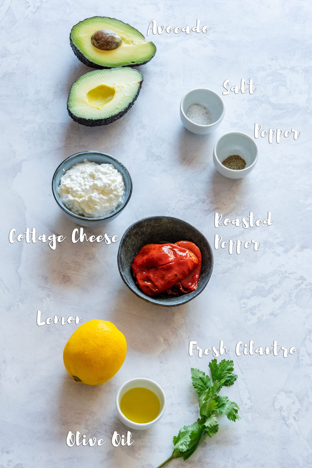 Ingredients of cottage cheese dip - cottage cheese, avocado, roasted pepper, cilantro, olive oil and seasoning.