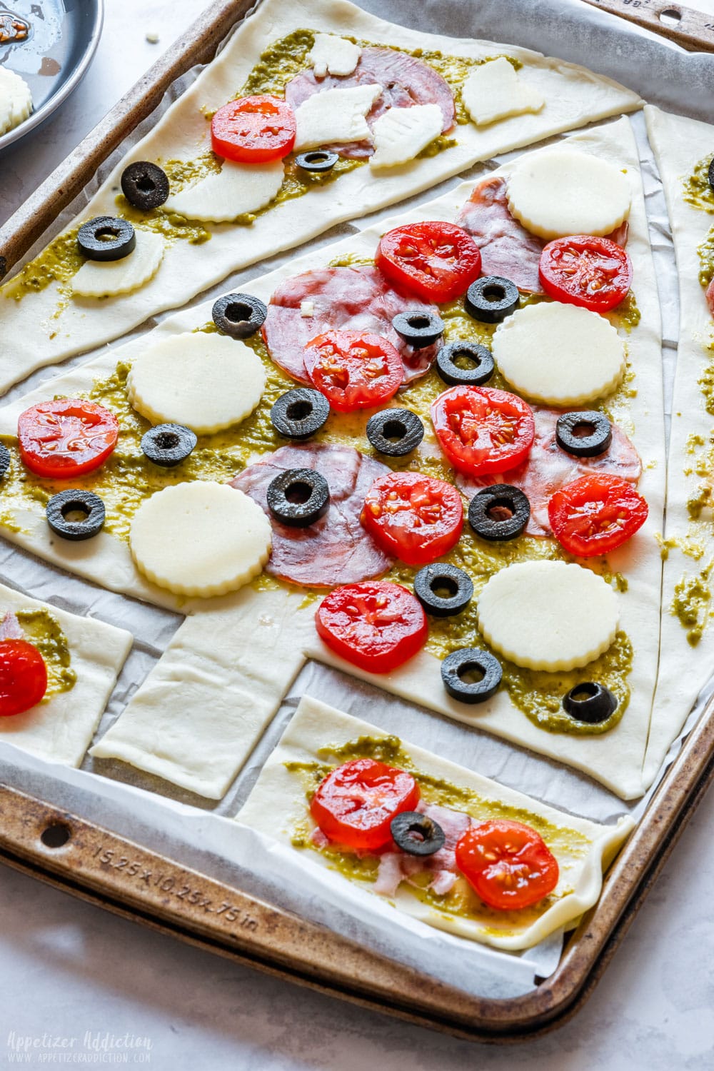 Christmas tree pizza with toppings before baking.