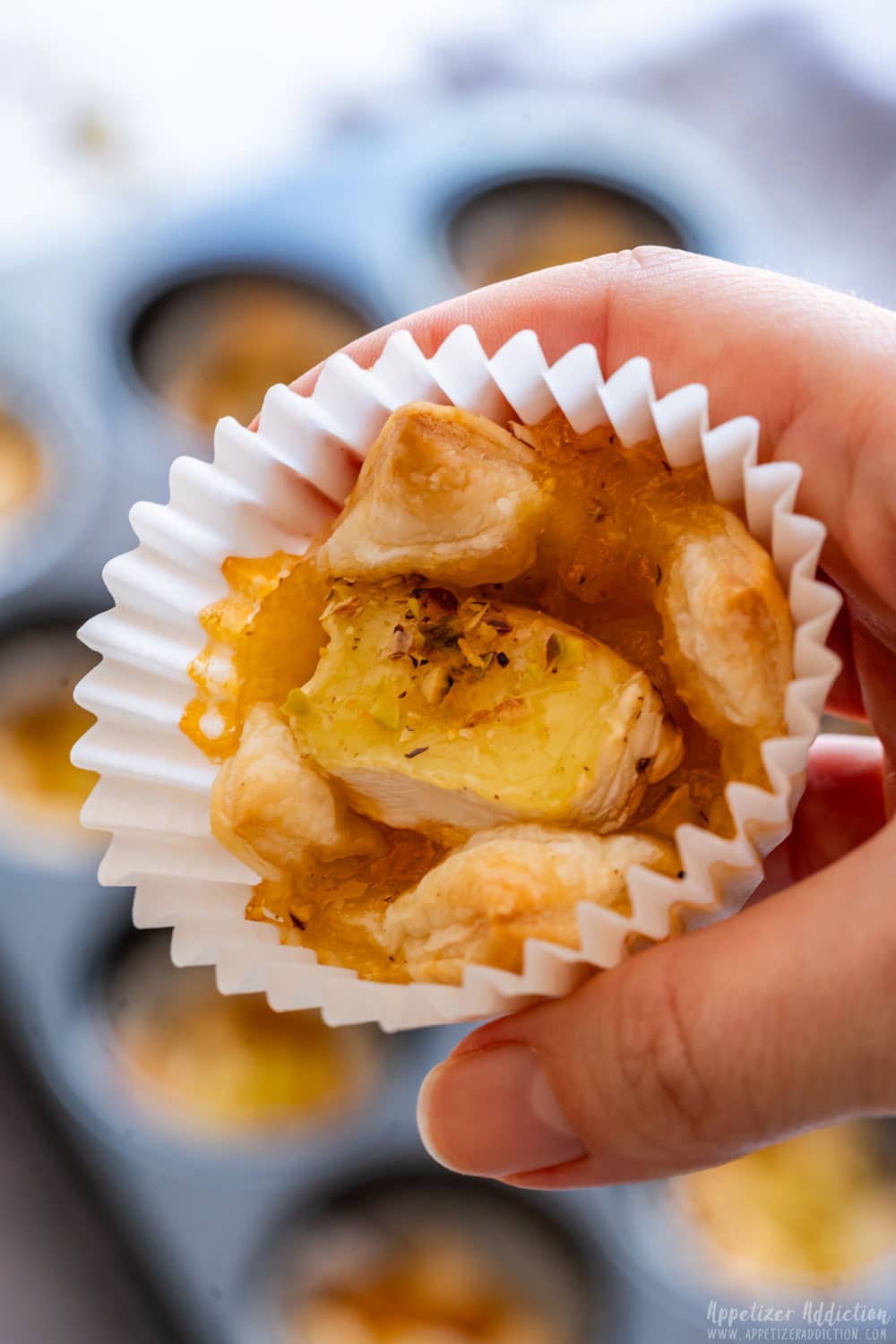 Close-up of brie bites with puff pastry and apricot jam.