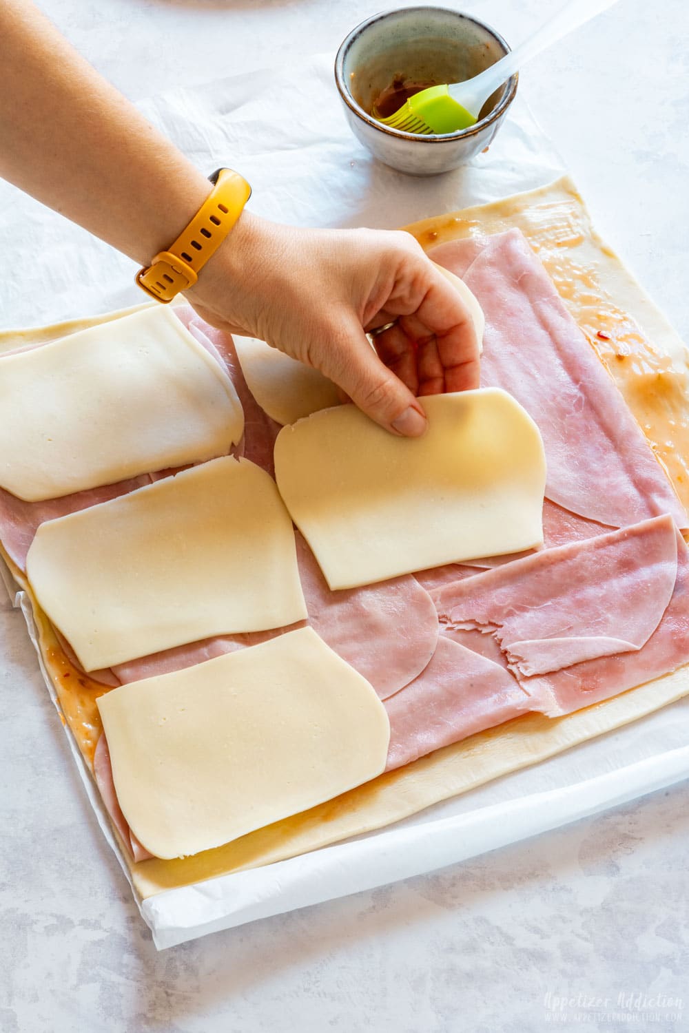 Showing how to make pinwheels with ham and cheese.