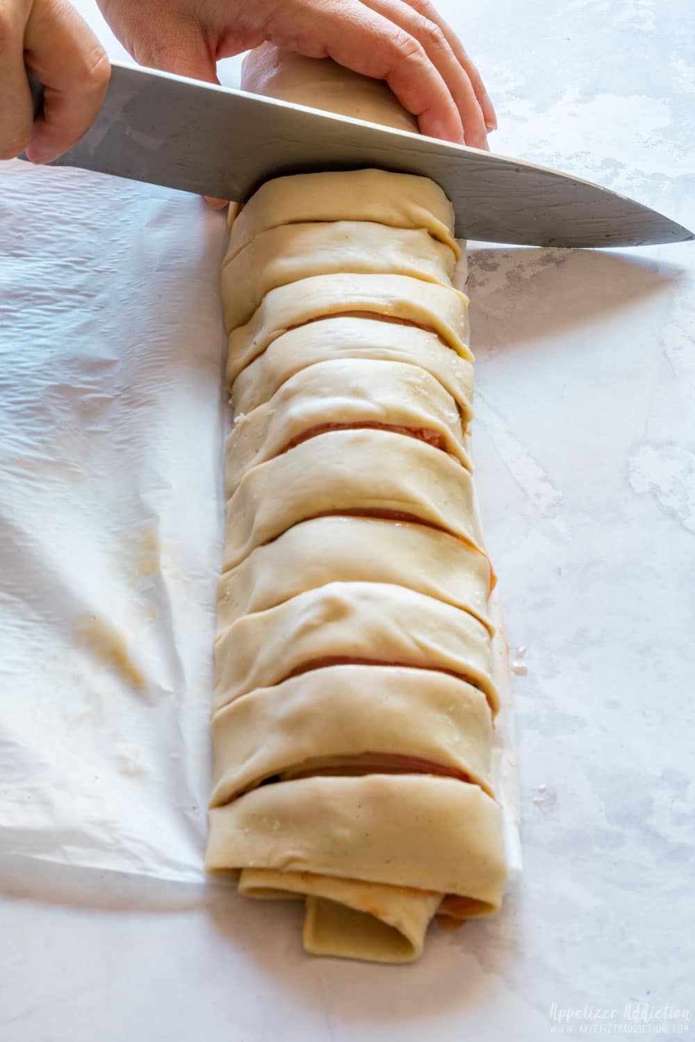 Slicing the puff pasty with filling.