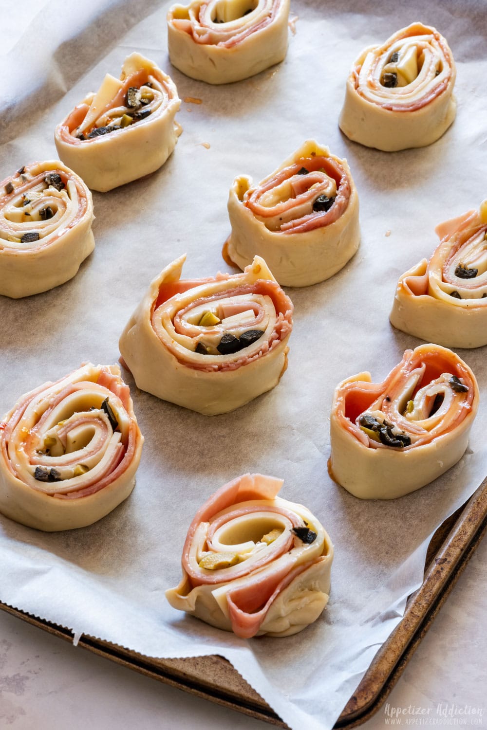 Unbaked pinwheels on the baking tray.