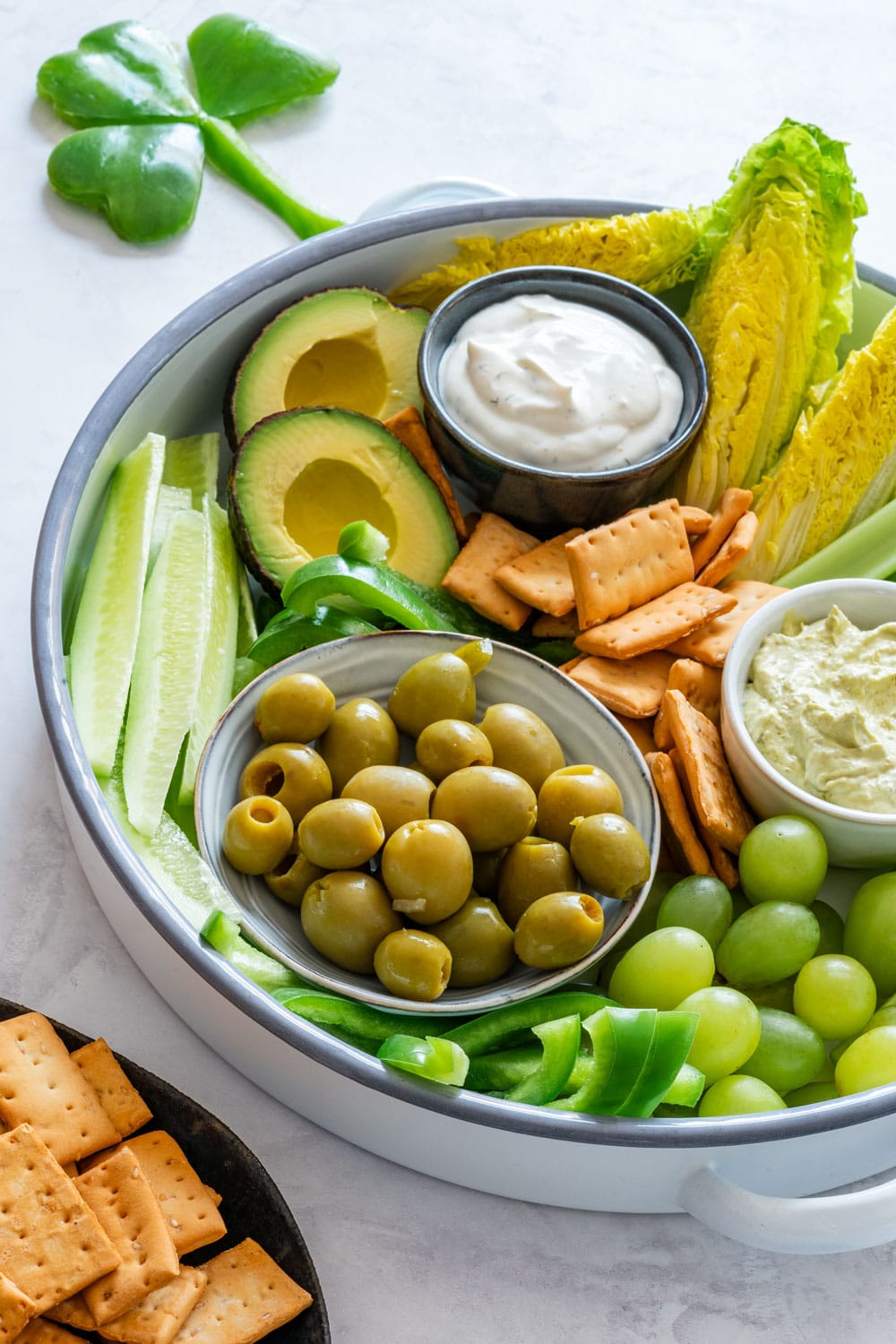 Green snack board with dip for St. Patrick’s Day.