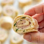 Close-up of turkey pinwheels with layers of cream cheese and turkey slices.