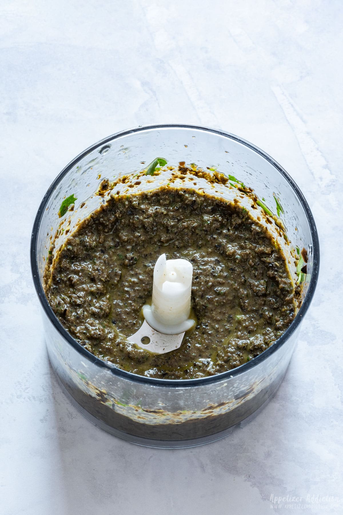 Tapenade paste in the food processor bowl.