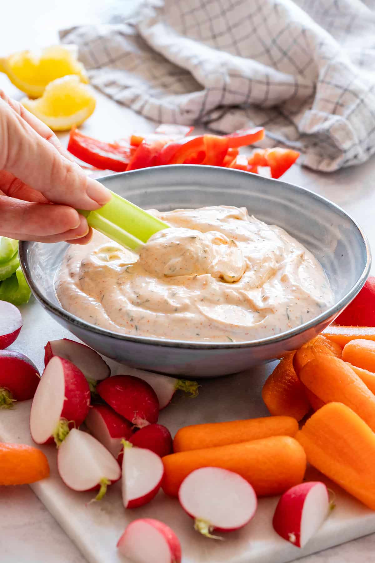 Dipping celery into homemade veggie dip.