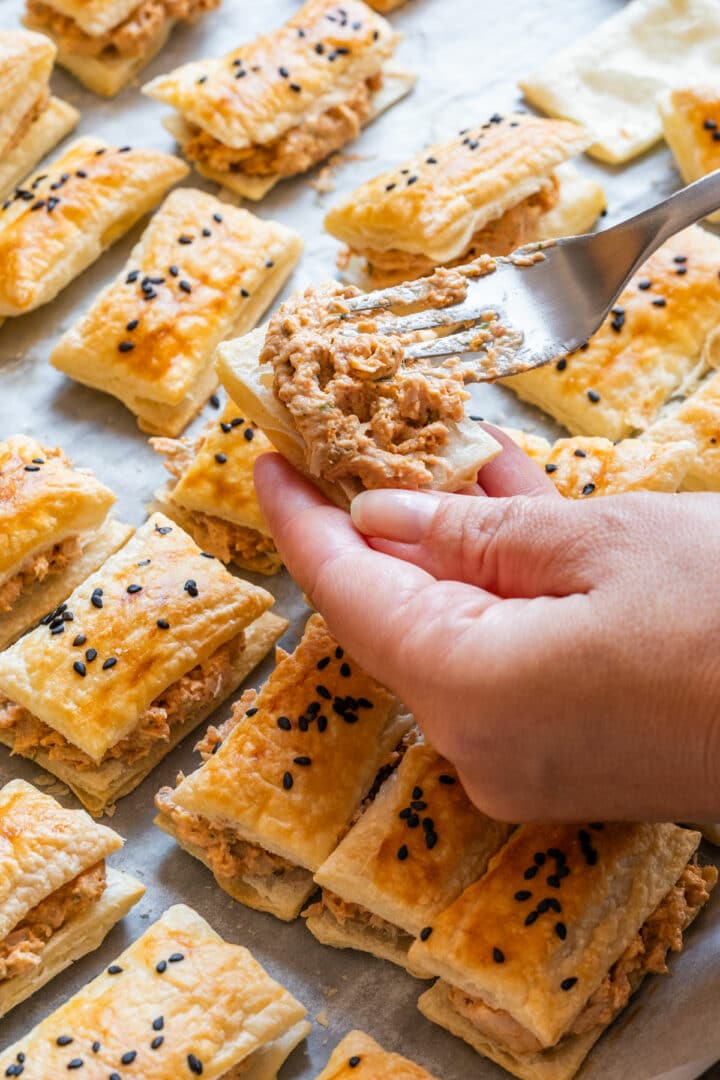 Chicken filling being spread onto one half of the baked puff pastry.