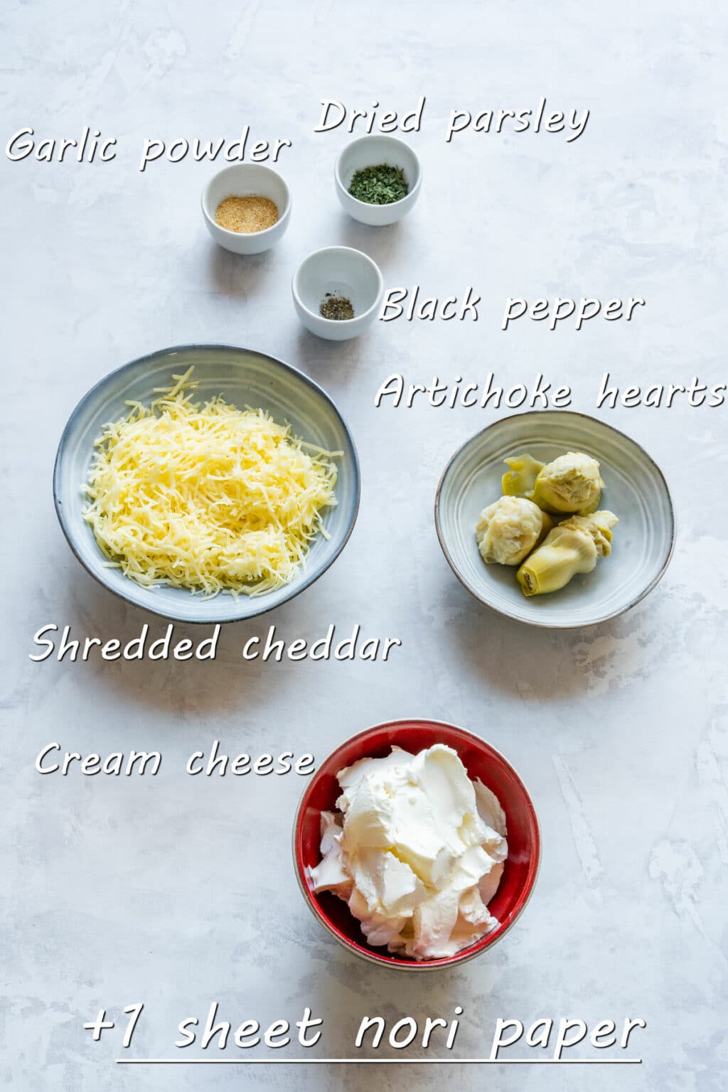 Ingredients for the cheese ball: cream cheese, shredded cheddar, artichoke hearts, garlic powder, dried parsley, black pepper and a sheet of nori.
