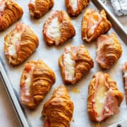 Mini ham and cheese croissants filled with Dijon, sliced ham and melted Gruyère. They start with store-bought mini croissants, can be filled up to 12 hours ahead and bake in 6 to 8 minutes. For a party, plan on 2 to 3 per person.